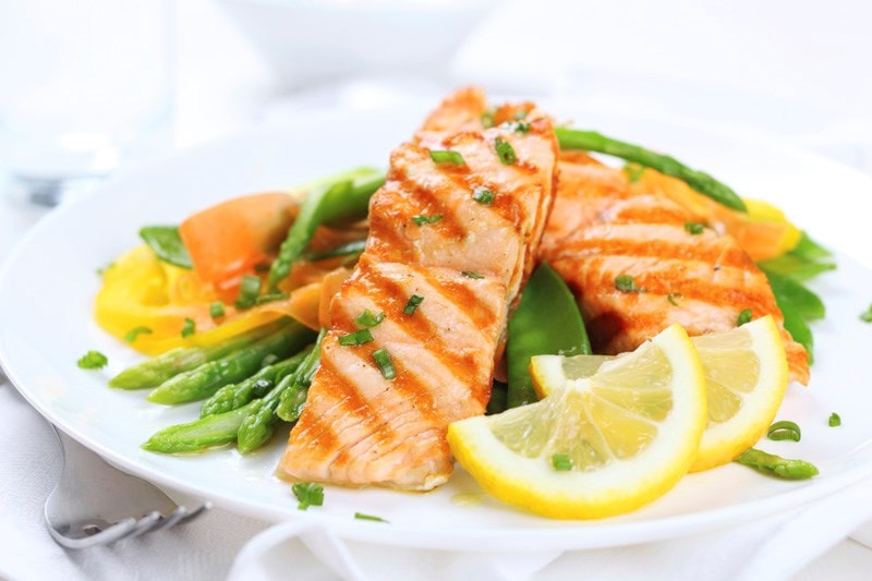 Salmon and vegetables on plate 