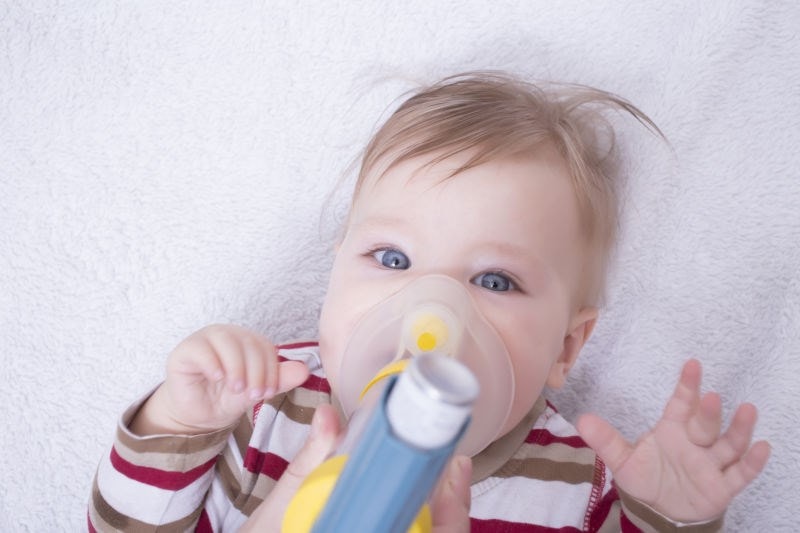 baby taking inhaler